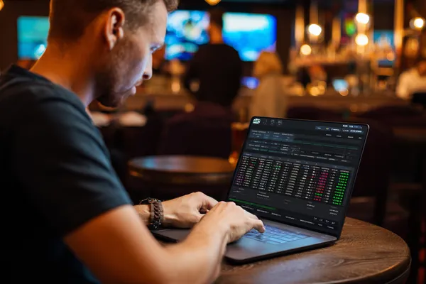 A confident dealer surrounded by casino chips inviting players to access their SLO16 account, reflecting quick and easy login options.